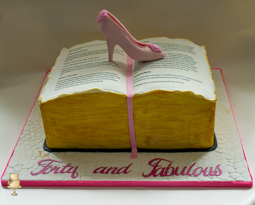 Book-shaped birthday cake with a pink high heel on top, featuring the text 'Forty and Fabulous'.
