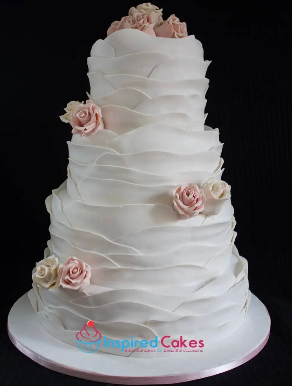 4 tier white wedding cake with sugar roses