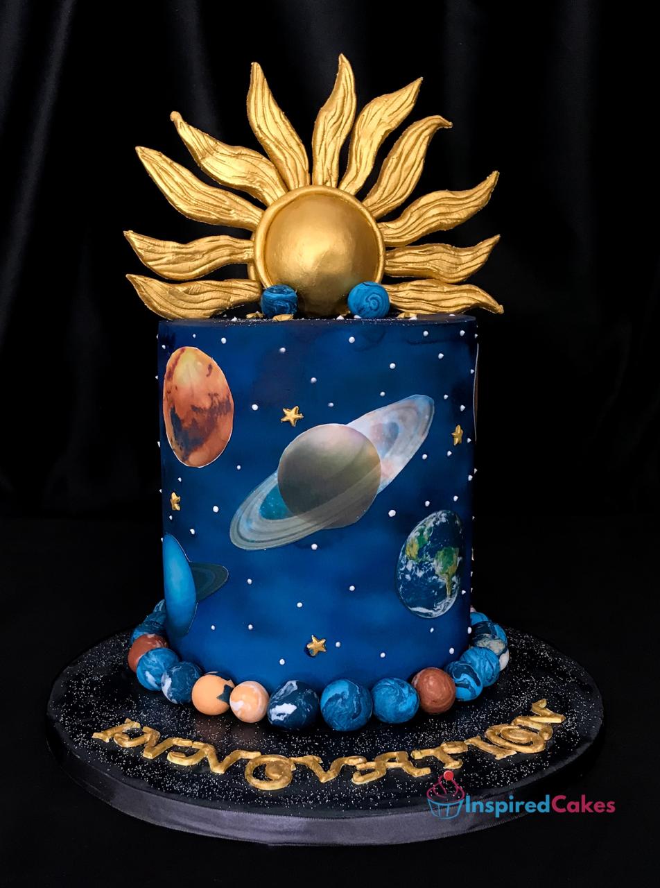 Space-themed cake with solar system design on a black background