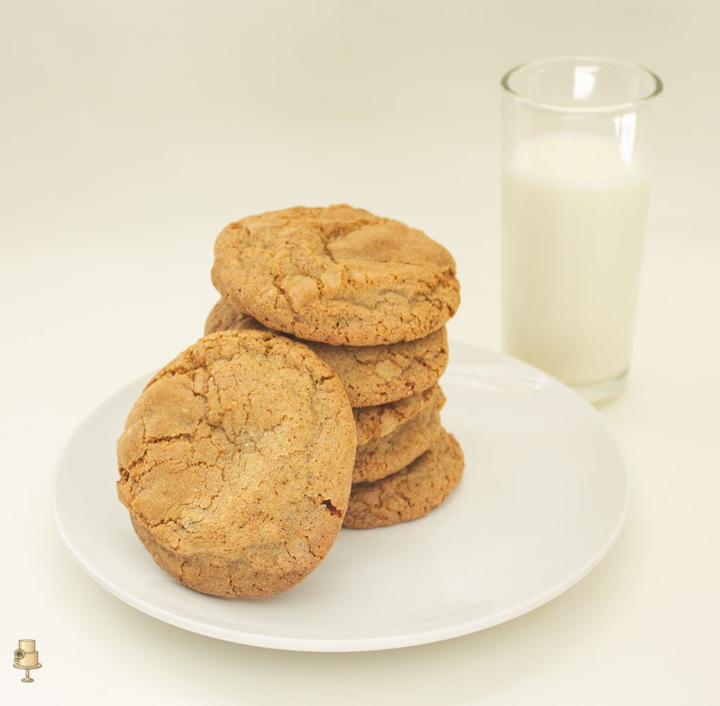 Ginger cookies on a plate with glass of milk