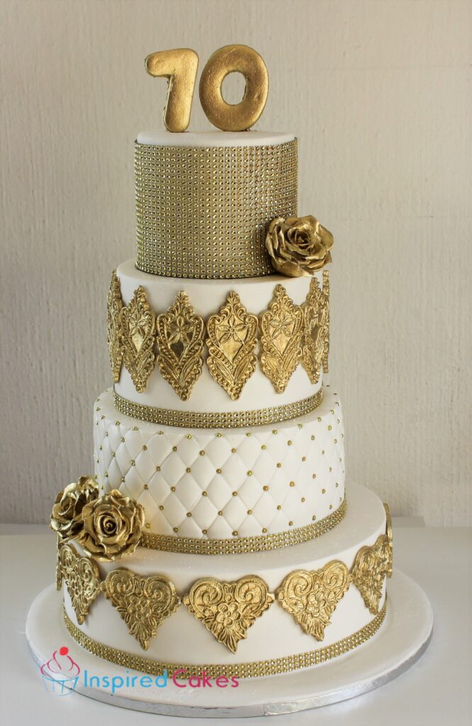 4 tier gold and white 70th birthday cake