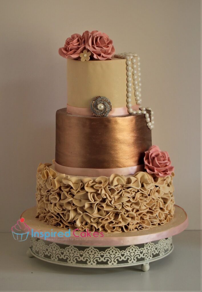 3 tier rose gold wedding cake with pearls