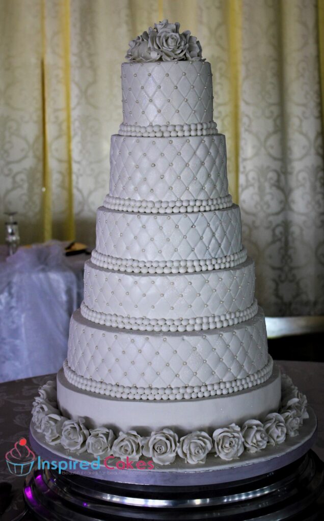 6 tier white wedding cake with sugar roses