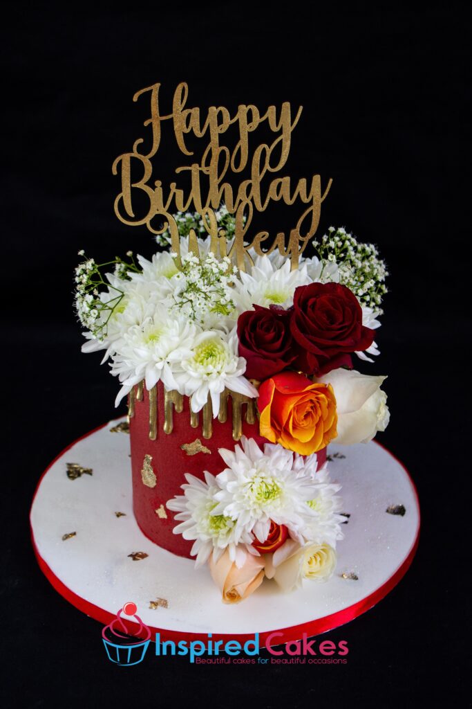 gold drip cake with fresh flowers cake topper
