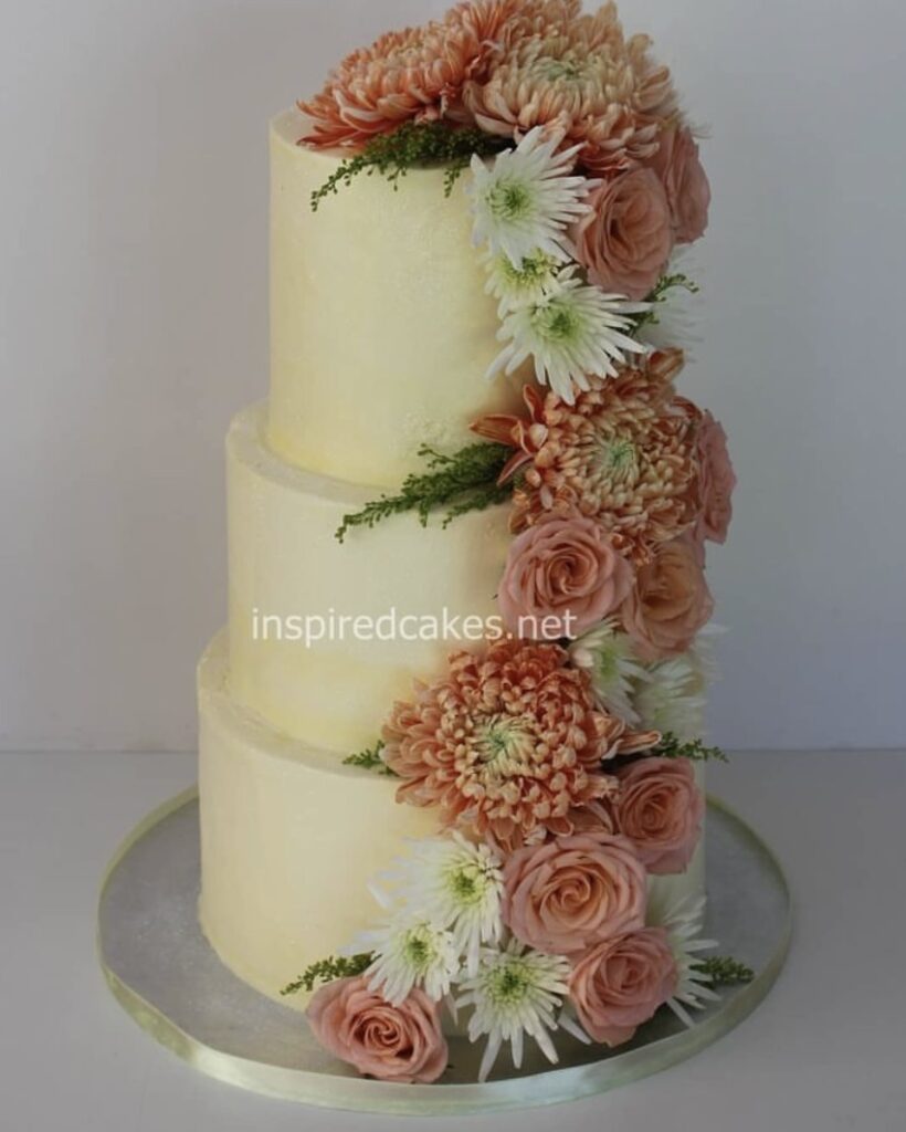 3 tier buttercream cake with fresh flowers